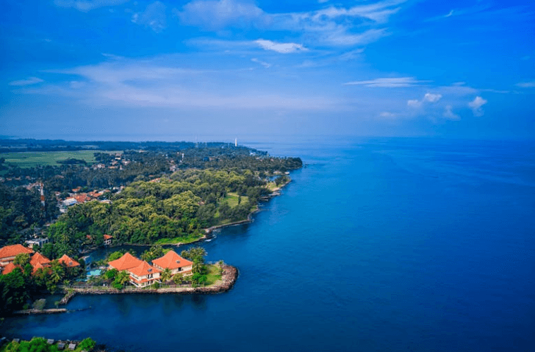 Vintage travel van with luggage on tropical palm tree road adventure - minimalist travel lifestyle