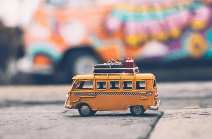 Airplane wing view from window during flight over turquoise ocean - budget airline travel tips